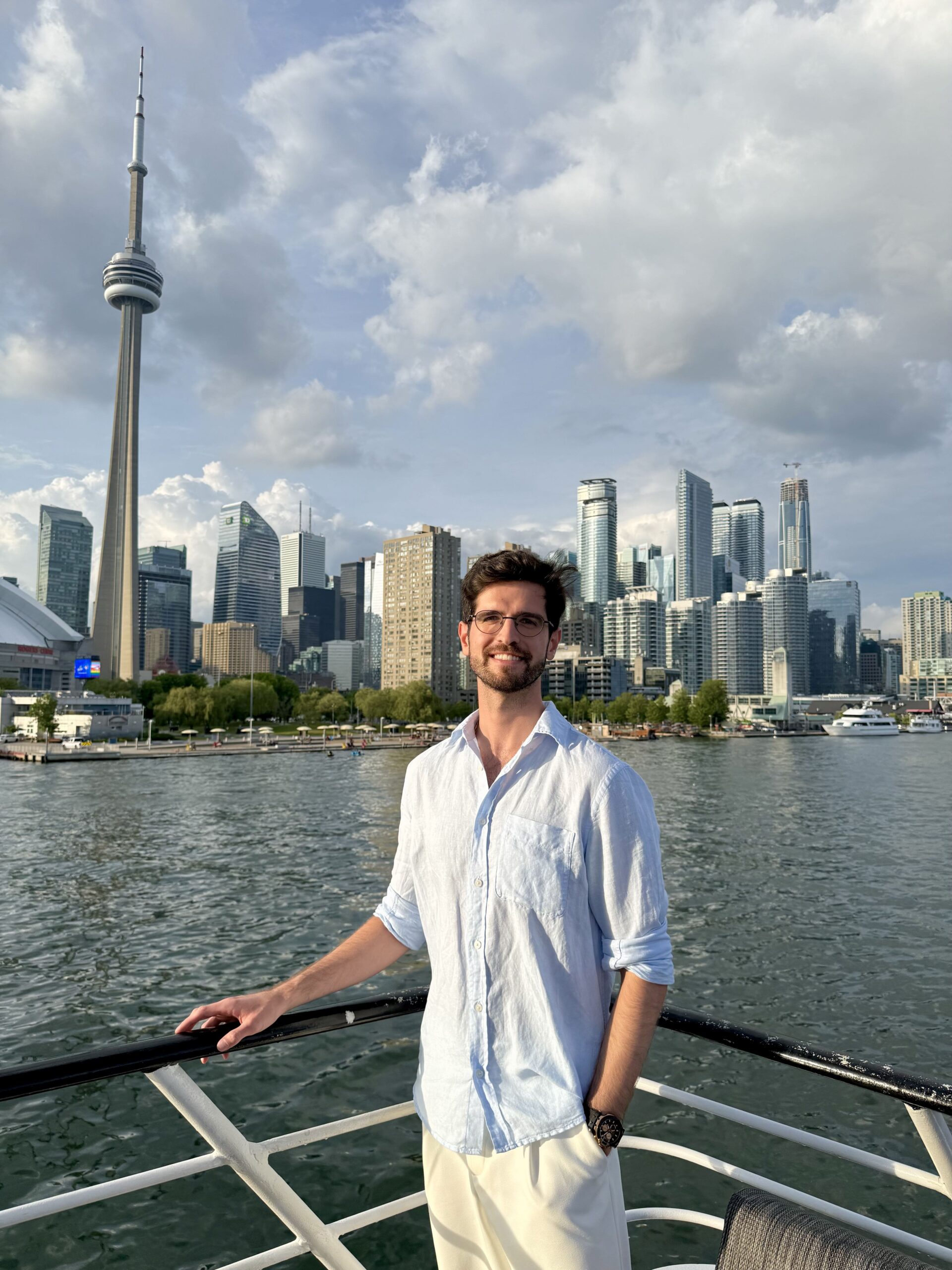 On the deck of the Toronto Odyssey with the CN Tower and skyline behind